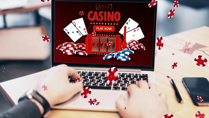 Male sat using a laptop for a online casino & gaming