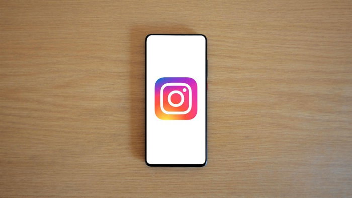 mobile phone on the a desk showing the Insta logo