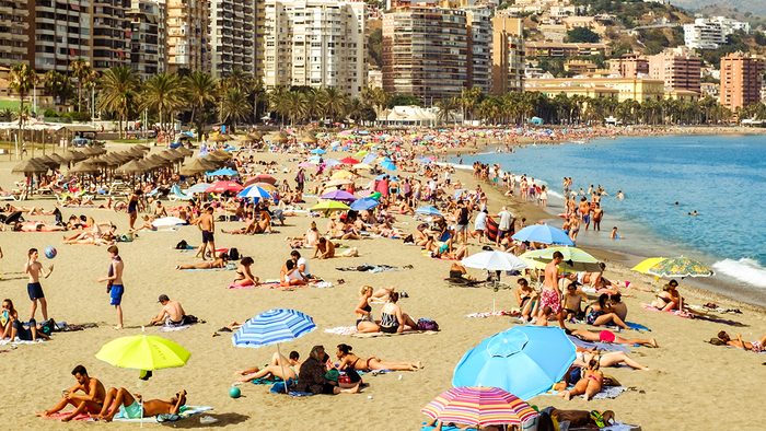 A Malaga beach scape full of people.