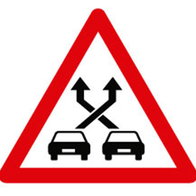 Spain's new P-35 road sign warns drivers that they are approaching a weaving lane where entering and exiting traffic cross paths.