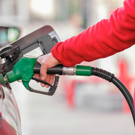 Person filling up their car with petrol.