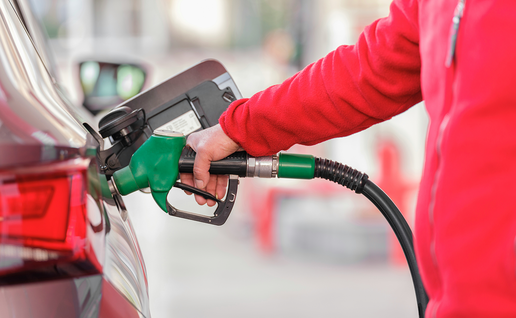 Person filling up their car with petrol.