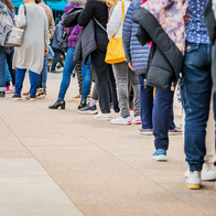 Large number of anonymous people queue up for something