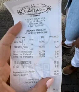 A hand holding a receipt from an ice cream shop