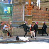 Police and civilians chasing after a man in attempts to arrest him
