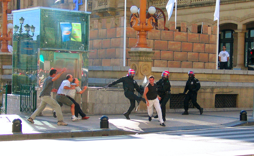 Police and civilians chasing after a man in attempts to arrest him
