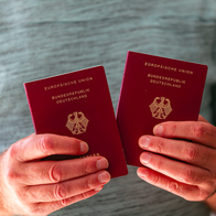 A man holding two German passports