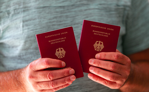 A man holding two German passports