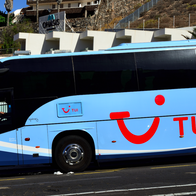A tourist bus parked on a hill