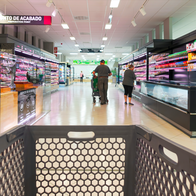 View of the supermarket aisle with a shopping trolley in the foreground