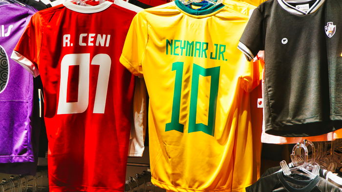 Football shirts hanging in a store