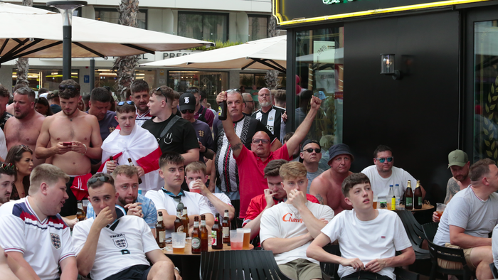 England fans sitting outside a bar