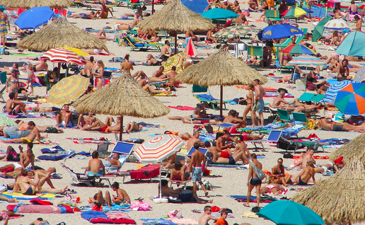 A packed beach with tourists