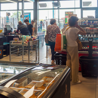 Customers utilizing self checkout kiosks at a contemporary ALDI store