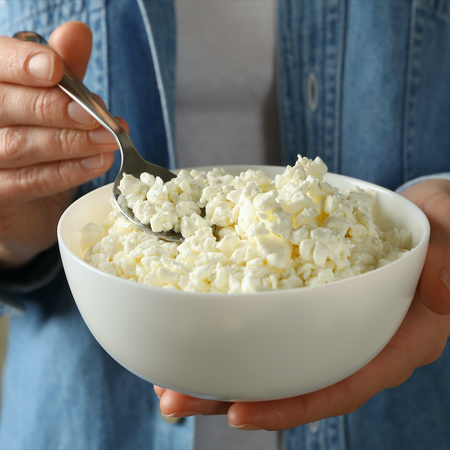 Man holding a bowl of cottage cheese