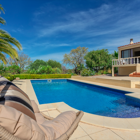 Luxury villa in Portugal with a pool and palm trees