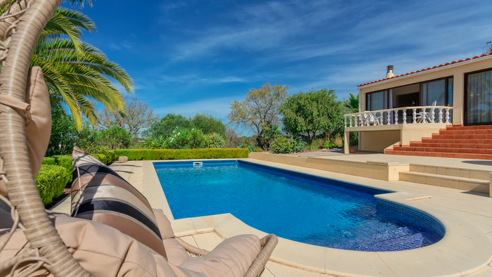 Luxury villa in Portugal with a pool and palm trees
