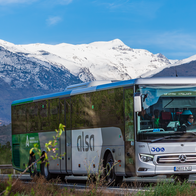 Alsa coach travelling along a motorway with Sierra Nevada in the background