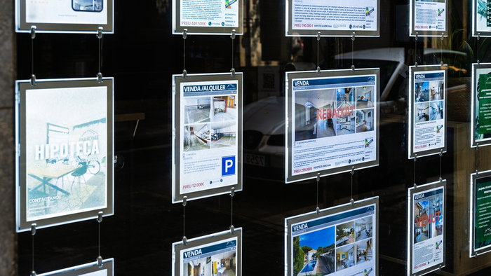 Property listings displayed in the window of a Spanish estate agency, as Spain's Tax Agency launches inspections into suspected tax fraud in the real estate sector.