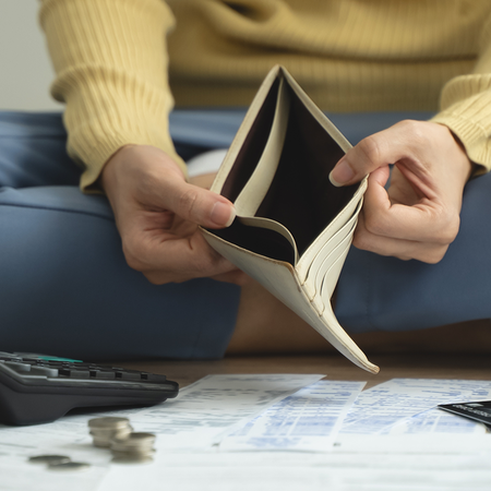 Person looking at an empty wallet.