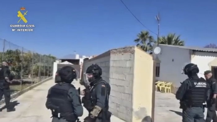 Guardia Civil officers raid Alhaurin home.