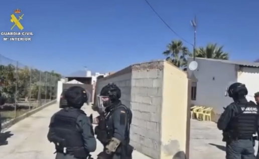 Guardia Civil officers raid Alhaurin home.