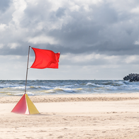 Warning flag on beach in rough conditions.