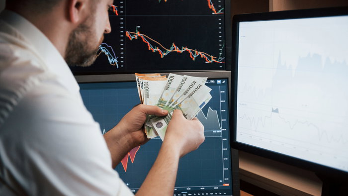 Bearded man holding man in front of a computer screen