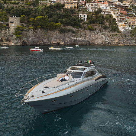 Couple on the bow of a boat with a view of Amalfi coast