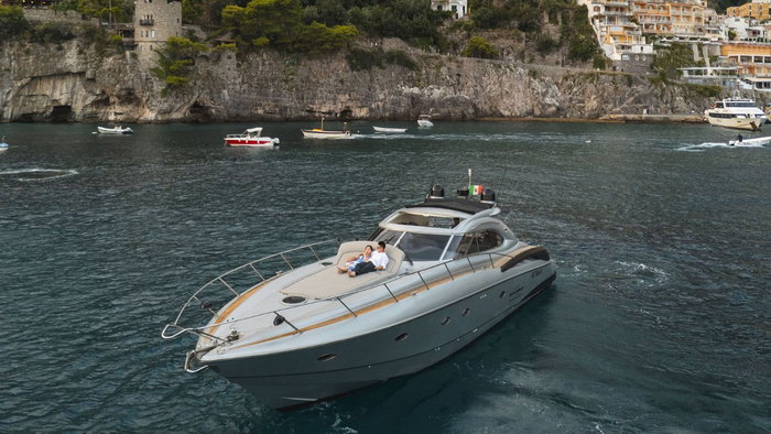 Couple on the bow of a boat with a view of Amalfi coast