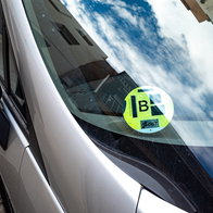 DGT environmental sticker displayed on a car windscreen in Spain.