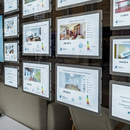 Property listings displayed in the window of a Spanish estate agency as house prices continue to rise across the country.
