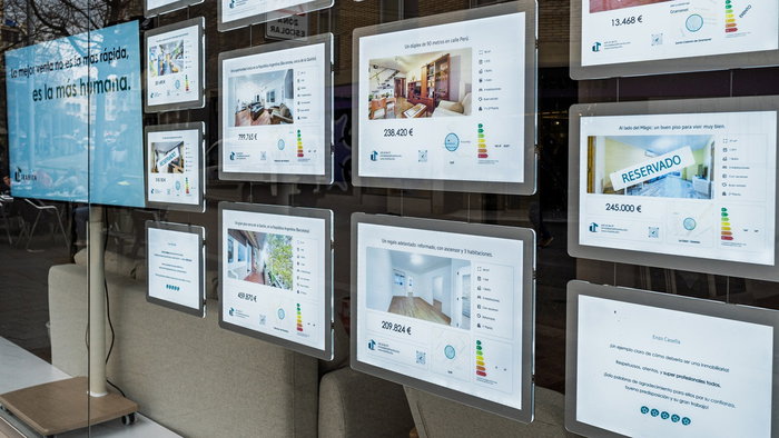 Property listings displayed in the window of a Spanish estate agency as house prices continue to rise across the country.