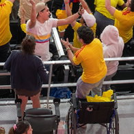 Wheelchair users standing up to celebrate Colombias goal