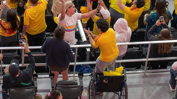 Wheelchair users standing up to celebrate Colombias goal