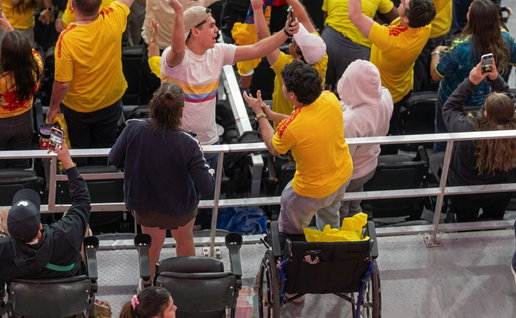 Wheelchair users standing up to celebrate Colombias goal