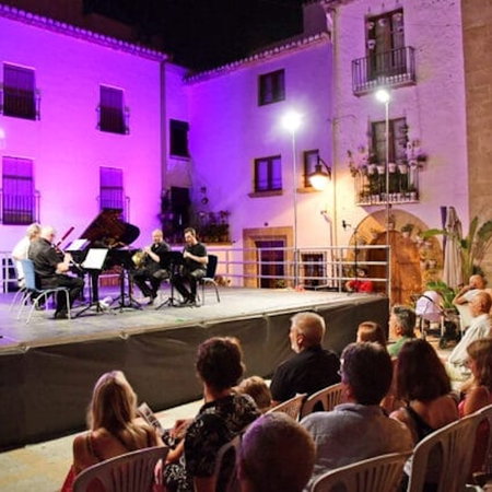 Luxury villa on top of a hill with the sea in the background.