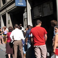 People queue outside an immigration office in Spain as uncertainty grows over the government's migrant regularisation plan.