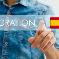 Person pointing at a digital immigration interface with the Spanish flag, symbolising residency, immigration rules and legal requirements for foreign residents in Spain.