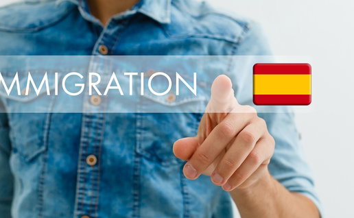 Person pointing at a digital immigration interface with the Spanish flag, symbolising residency, immigration rules and legal requirements for foreign residents in Spain.