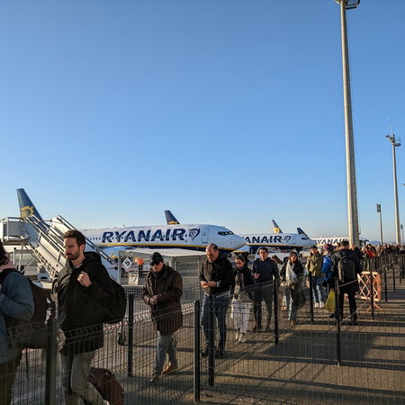 Passengers queue to board Ryanair aircraft on the airport apron as the airline expands its European route network for summer 2026.