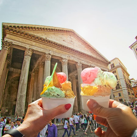 Couple holding up two ice creams by the Pantheon in Rome