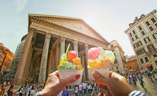 Couple holding up two ice creams by the Pantheon in Rome