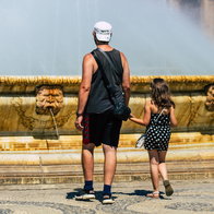 Father and daughter near a fountain in Seville