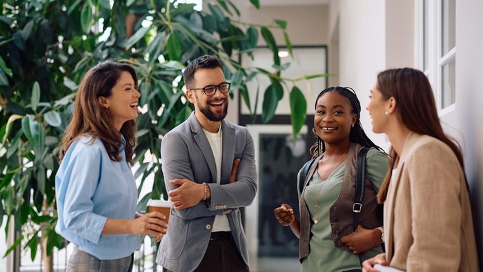Happy business team communicating on a break in the office.