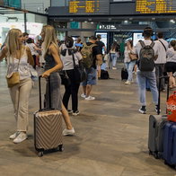 Passengers waiting in train station for information on their train