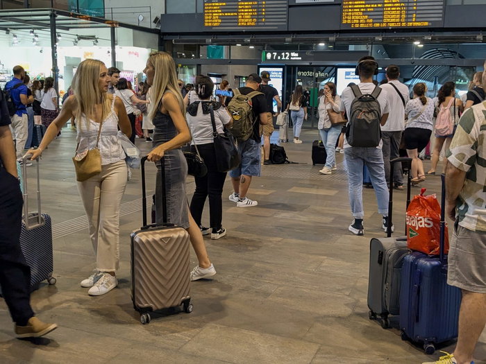 Passengers waiting in train station for information on their train