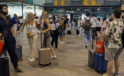 Passengers waiting in train station for information on their train