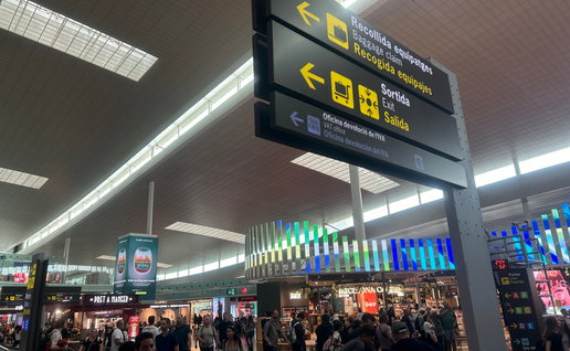 A busy airport with a baggage collection sign