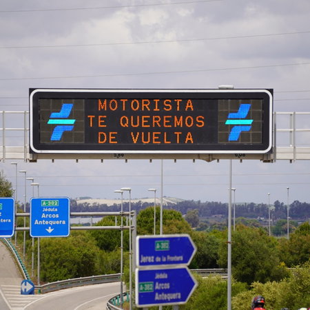 Electronic motorway sign on a Spanish highway during the DGT's summer traffic operation, reminding drivers to travel safely.
